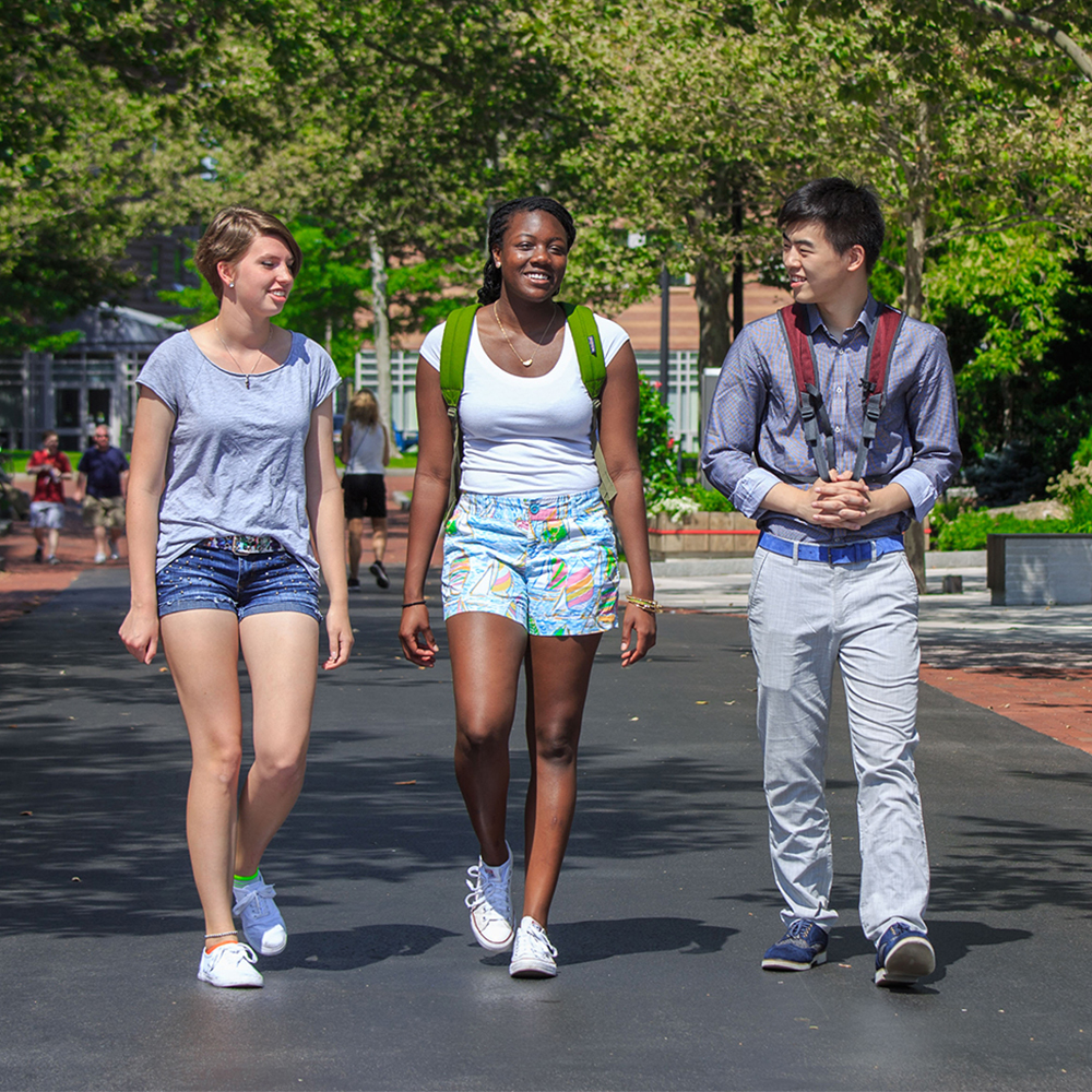 Ciara and two friends walking down a path on campus