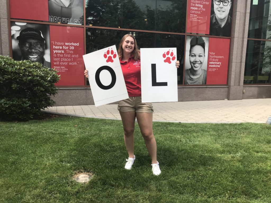 Emily Keith holding a sign